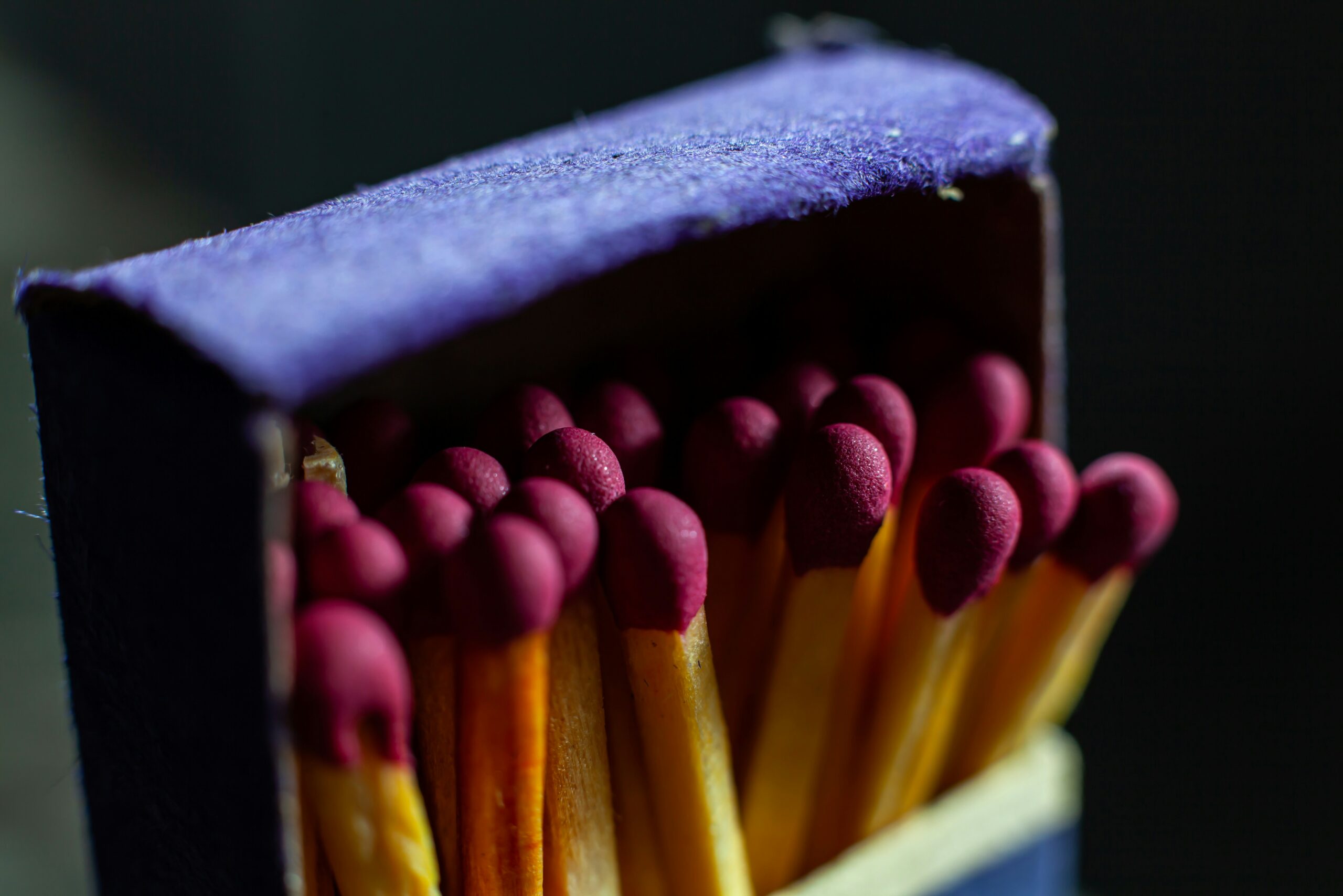 Macro photo of wooden matches in a cardboard box. Photo shared with a Creative Commons license by Ian Talmacs on Unsplash.